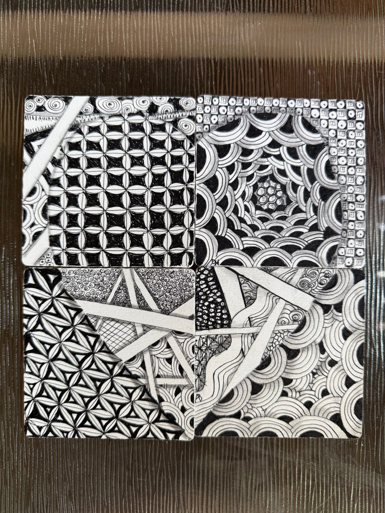 Four zentangle art pieces grouped together forming a heart created by online workshop participants